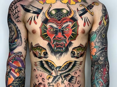 A person displaying a colorful tattoo design featuring a demon mask, fish, and an eagle on their torso.