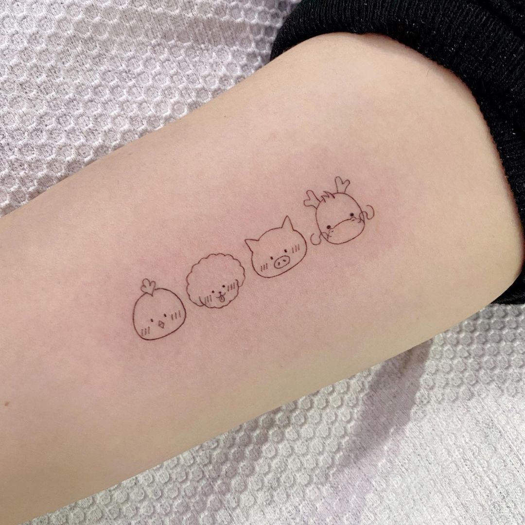 Four cute animal tattoos on an arm