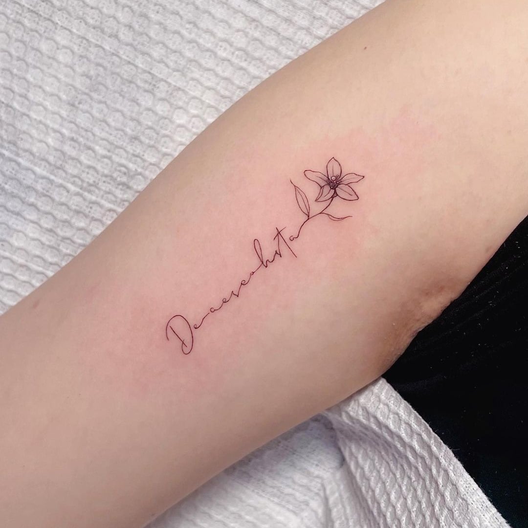Delicate floral tattoo on inner arm