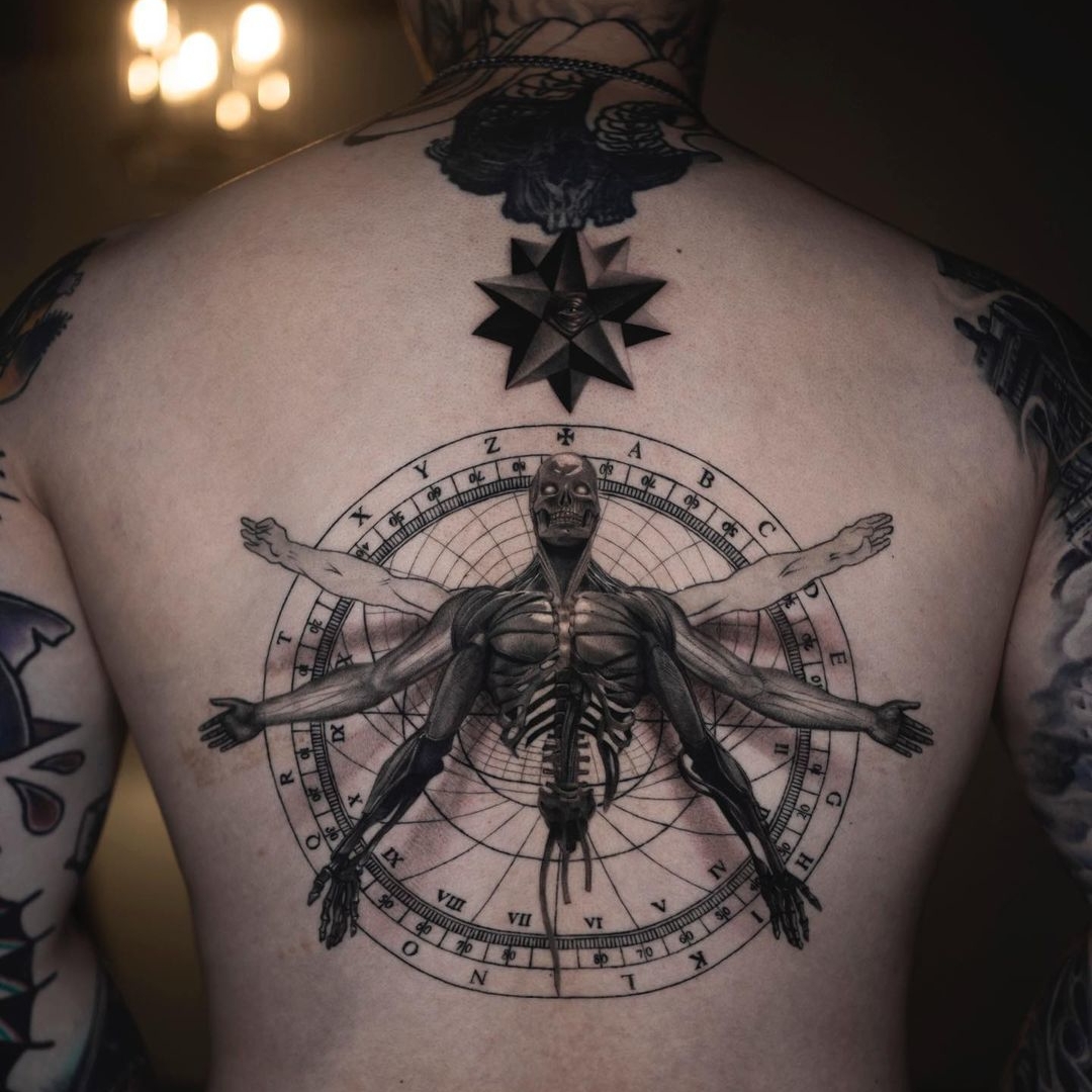 Detailed anatomical tattoo design on a person's back
