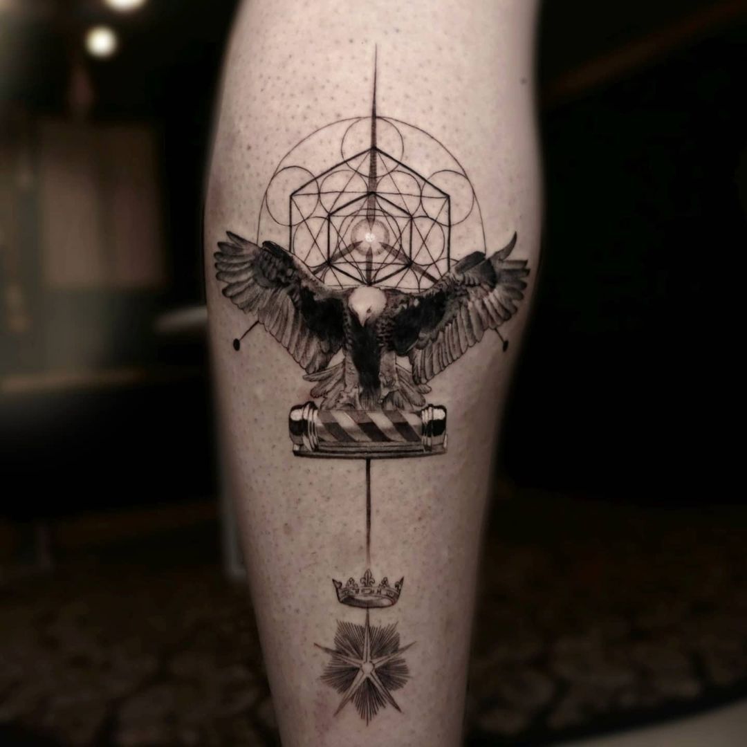 Intricate tattoo featuring an eagle, geometric patterns, and symbols