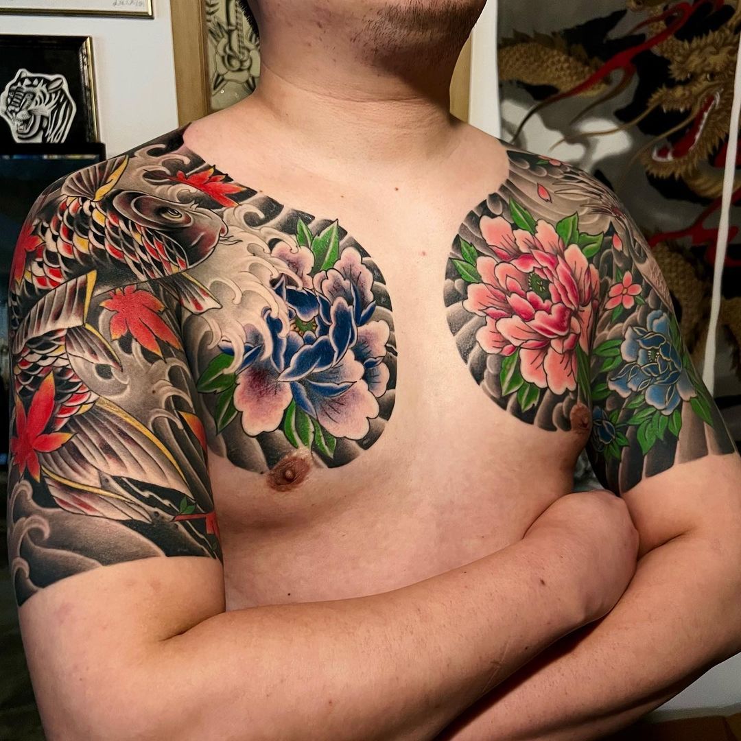 Tattoo art featuring floral designs on a man's upper body