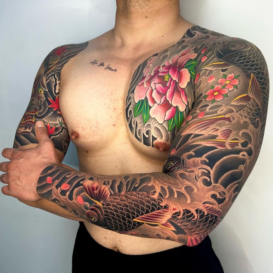 Colorful tattoo art featuring koi fish and peonies on a man's arms