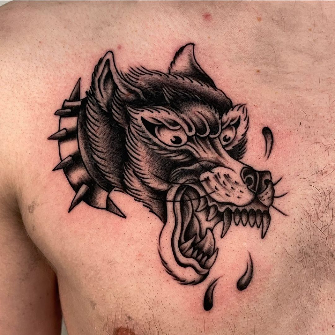Detailed tattoo of a wolf's head on skin.