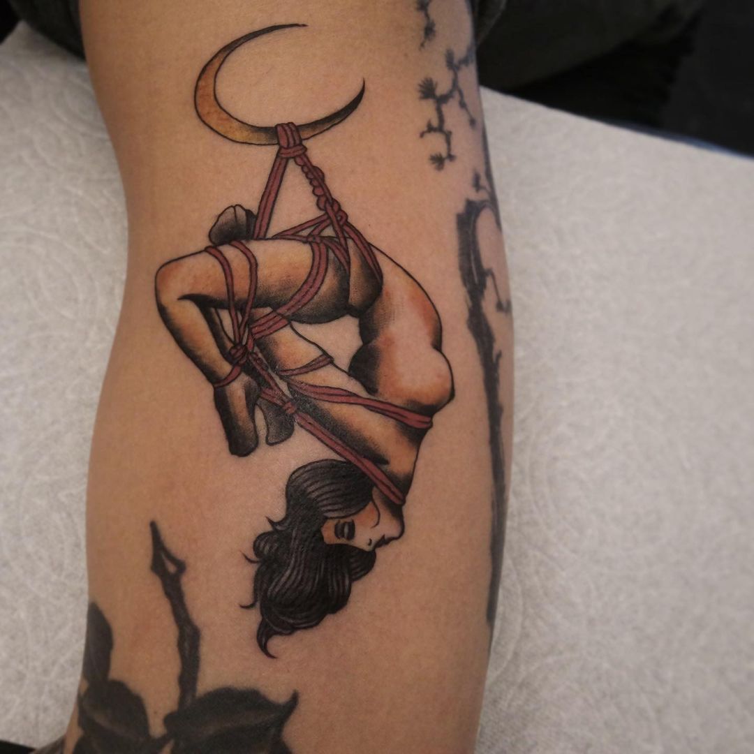 Tattoo design of a woman suspended with ropes and a crescent moon in the background.