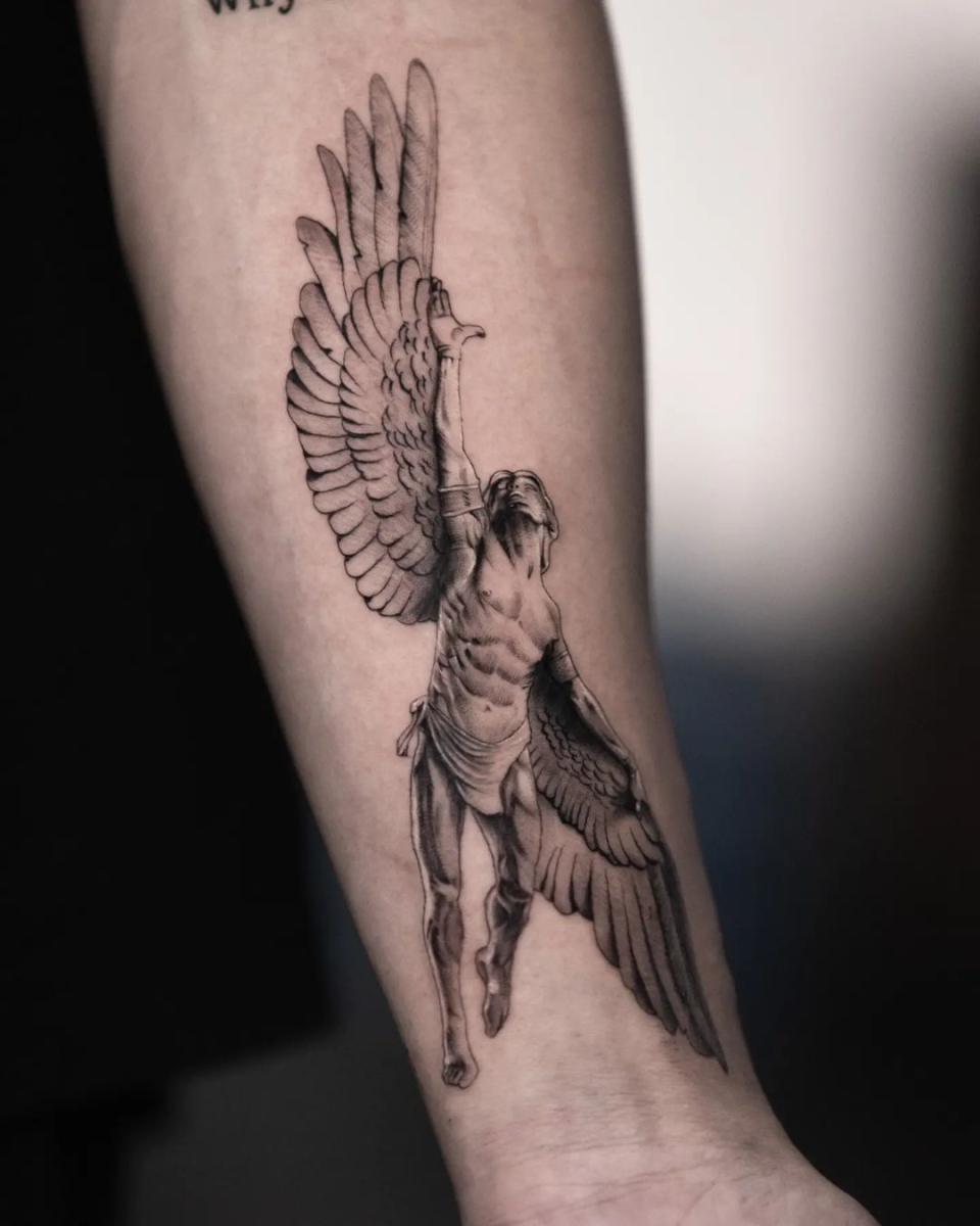 Angel tattoo on forearm with detailed wing design