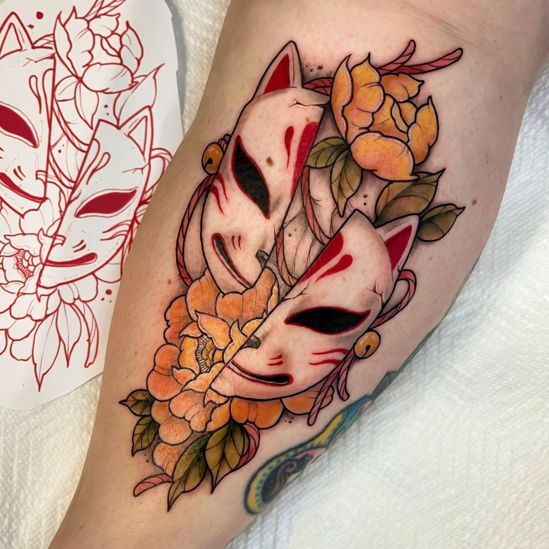 Tattoo of masked fox and flowers on arm