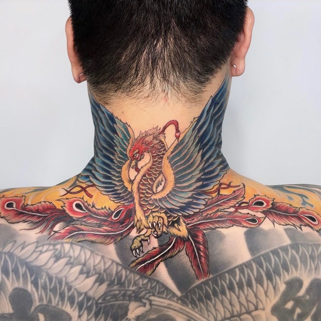 Vibrant tattoo of a phoenix on a man's back