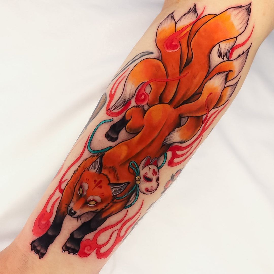 Vibrant orange fox tattoo with a white fox mask