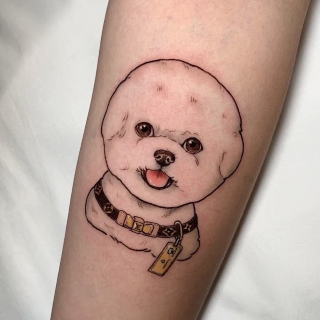 Tattoo of a fluffy dog on an arm