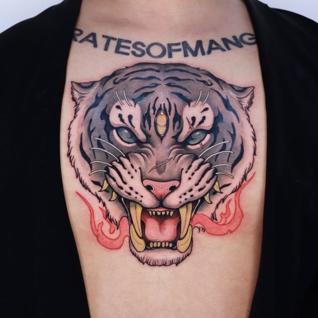 Detailed tiger tattoo design on chest.