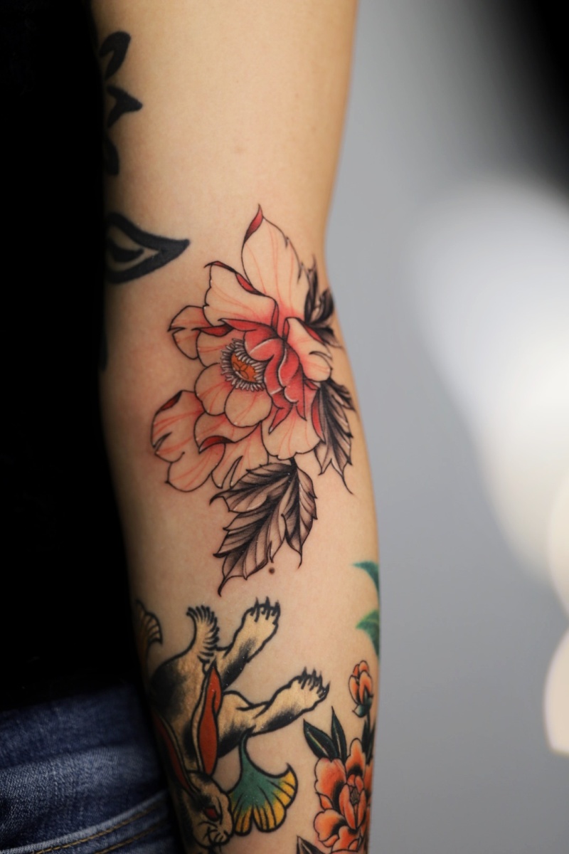 Colorful floral tattoo on an arm